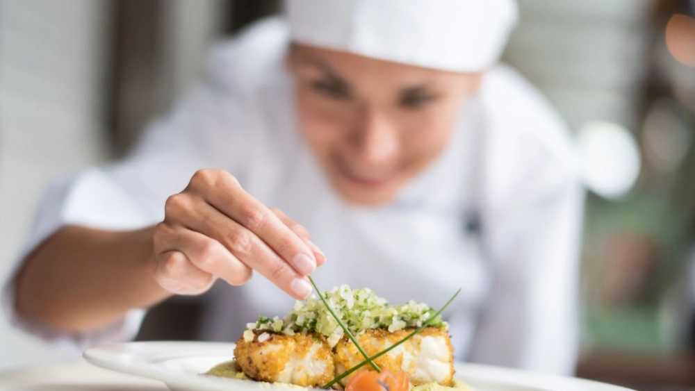 Chef at kitchen serving food