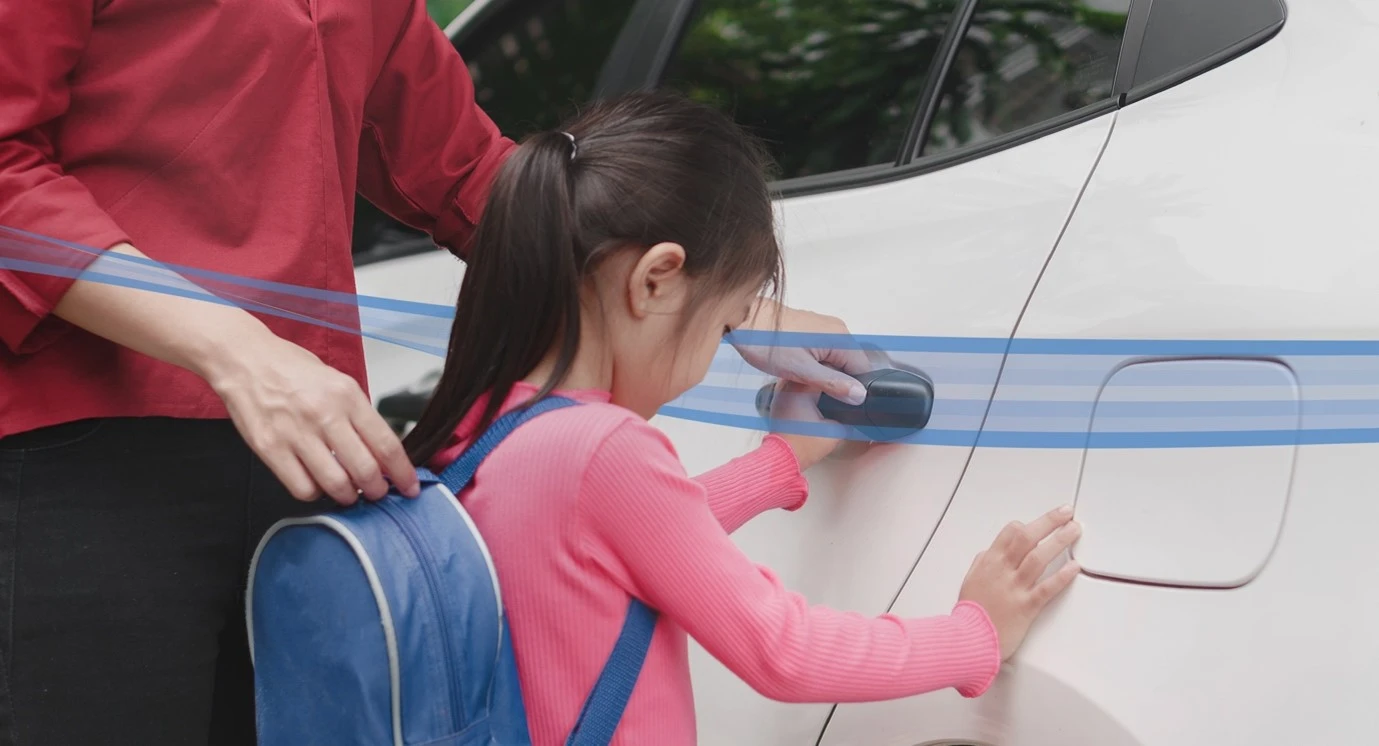 Young girl opening car door